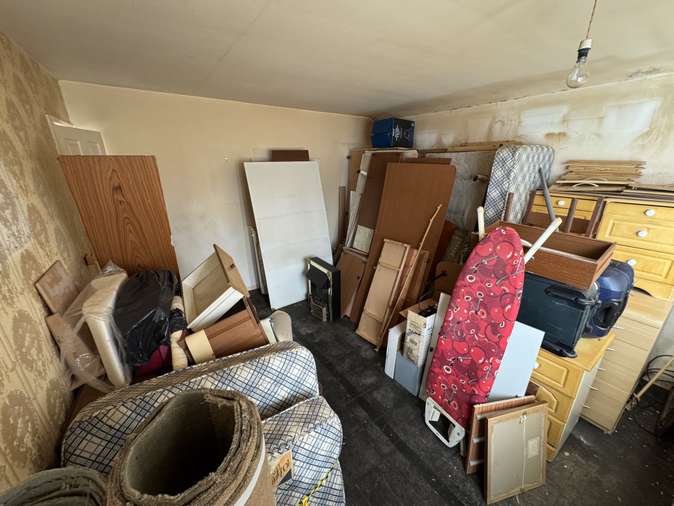Room full of furniture, doors, carpet and household items before clearance